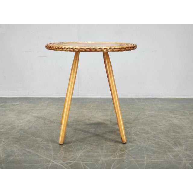 A charming Mid-Century Modern rattan and beech side table designed by Jan Kalous in Czechoslovakia during the 1970s. The...