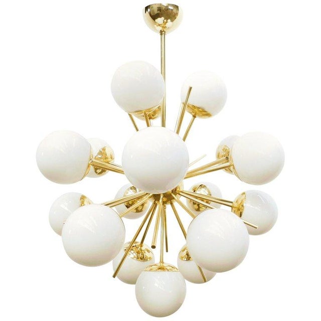 Italian sputnik chandelier with 18 glossy white Murano glass globes mounted on brass frame in lacquered polished brass...