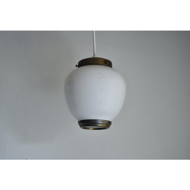 Art Deco Pendant Lamp composed of opaline glass with a beautiful pattern and brass details. Ready to use with a regular...