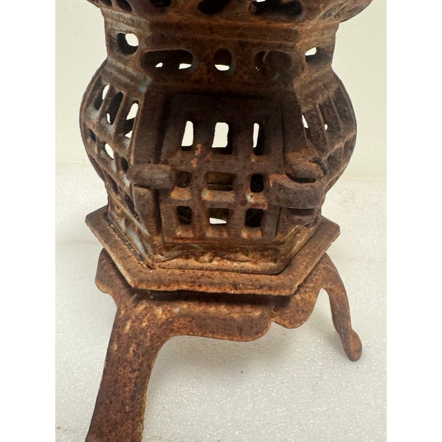 Japanese style cast iron pagoda garden lantern, often utilized as a decorative element in Japanese-inspired gardens....