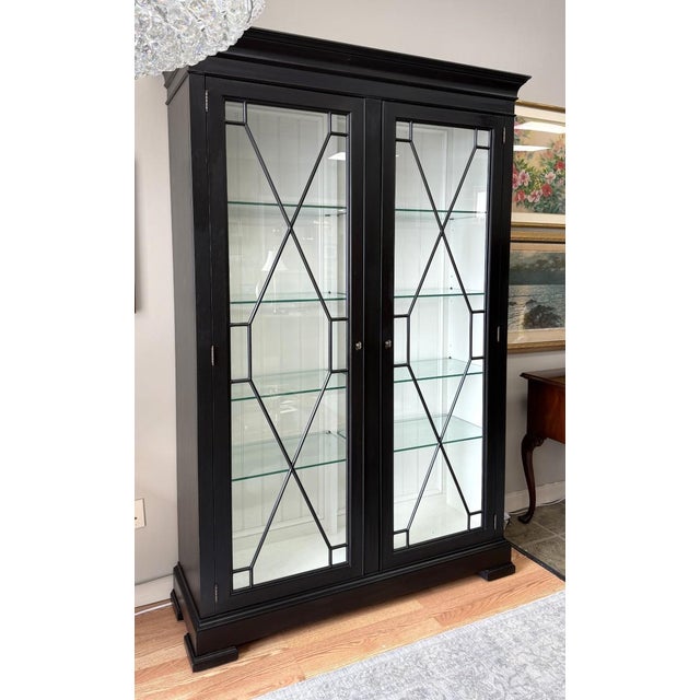 It is easy to become enamored with this handsome Ethan Allen Birkhouse Display Cabinet, showcasing elegant Chippendale-...