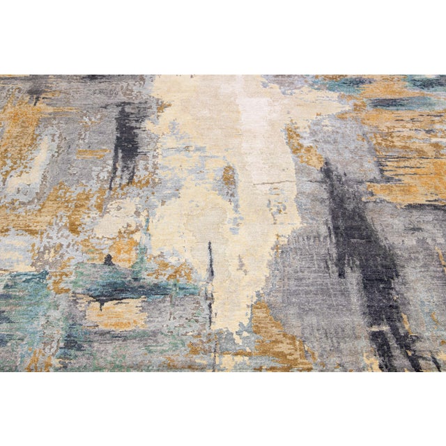 This wool and silk rug boasts a striking contemporary design featuring a beautiful motif in an elegant grey hue. The...