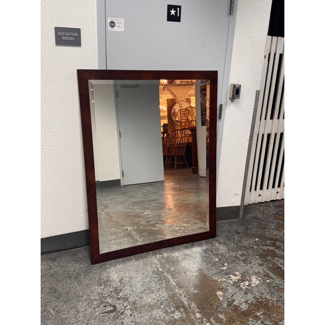Design Plus Gallery presents a Rectangular Burl Wood Frame Beveled Mirror. Swirling grain patterns and reddish-brown tones...