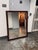 Design Plus Gallery presents a Rectangular Burl Wood Frame Beveled Mirror. Swirling grain patterns and reddish-brown tones...