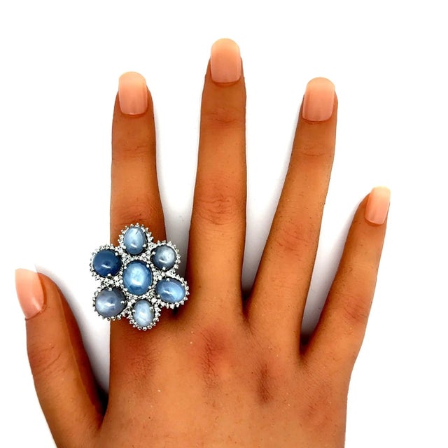 A striking cocktail ring featuring a 38.72 carats of blue star sapphire. There are a total of 7 star-sapphires, each with...
