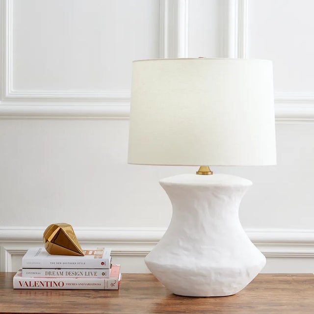 Hand crafted in ceramic the Bone one light table lamp by Hable has a unique shaped base and a black or white finish,...