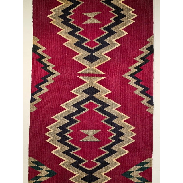 Beautiful vintage Navajo rug from the American Southwest features the revered Storm Pattern, a sacred and culturally...
