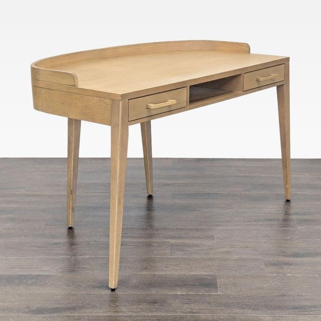 This stylish Four Hands desk features a light wood finish and a clean, modern design. It includes two spacious drawers and...