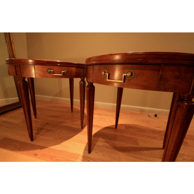 1960's Louis XVI style bouillotte table was made by Baker Furniture, features a bookmatched burl walnut top, fluted legs,...