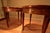 1960's Louis XVI style bouillotte table was made by Baker Furniture, features a bookmatched burl walnut top, fluted legs,...