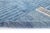 A dense, richly mottled blue field with a subtle linear rhythm running through it — understated, textural, and quietly...