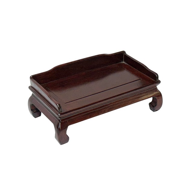 This miniature is a finely crafted wooden tray, showcasing a rich, dark mahogany finish that exudes timeless elegance. The...