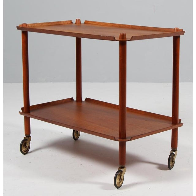 Poul Hundevad bar cart with raised sides. Brass wheels. Made by Poul Hundevad. This piece is attributed to the mentioned...