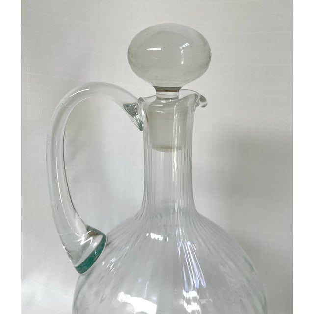 This beautiful pair of turn of the century hand blown glass decanters feature an etched botanical design on the swirled...