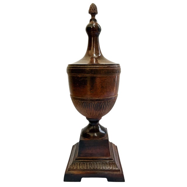 A sophisticated Neoclassical decorative urn crafted with a refined architectural silhouette. Features a classic ovoid body...