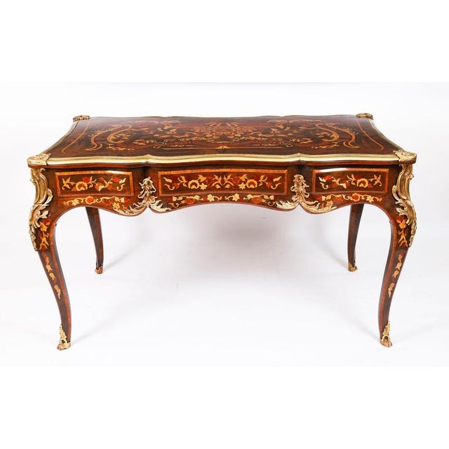 This is a gorgeous vintage French Louis Revival walnut, ormolu mounted, marquetry bureau plat, dating from the second half...