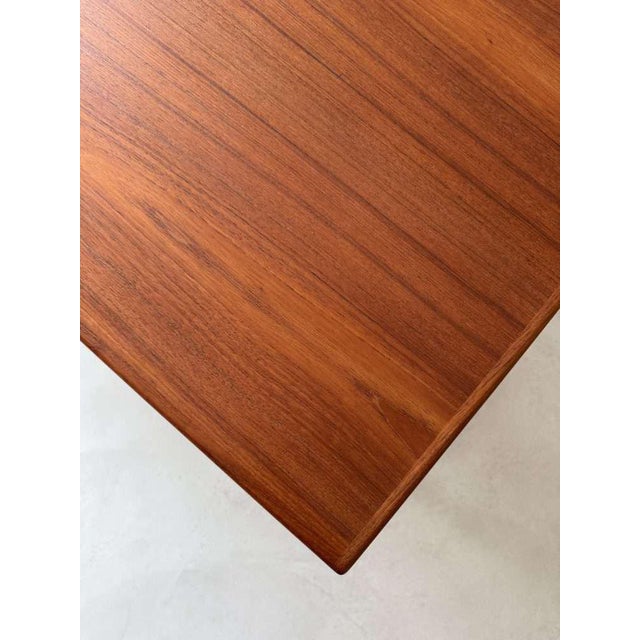 Large and refined, this coffee table was designed by Danish designer Niels Bach for the firm A/S in the 1960s. Combining a...