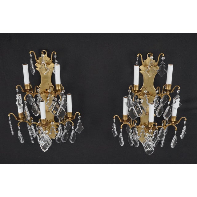 Fully restored French wall sconces with a brushed brass frame and pendeloque shaped crystals. These were original to the...