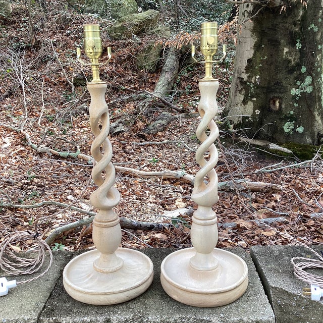 A striking pair of custom table lamps created from vintage carved wood candlesticks, newly and professionally wired and...