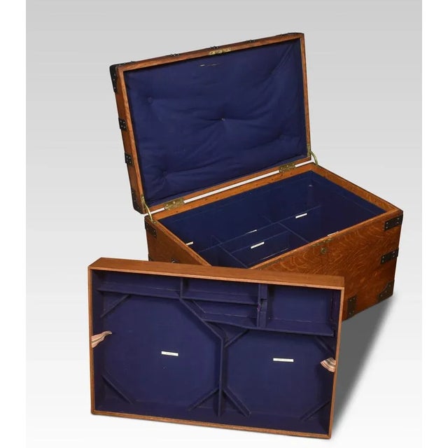 19th-century oak and iron-bound silver chest, applied with handles and corner brackets, opening to reveal an arrangement...