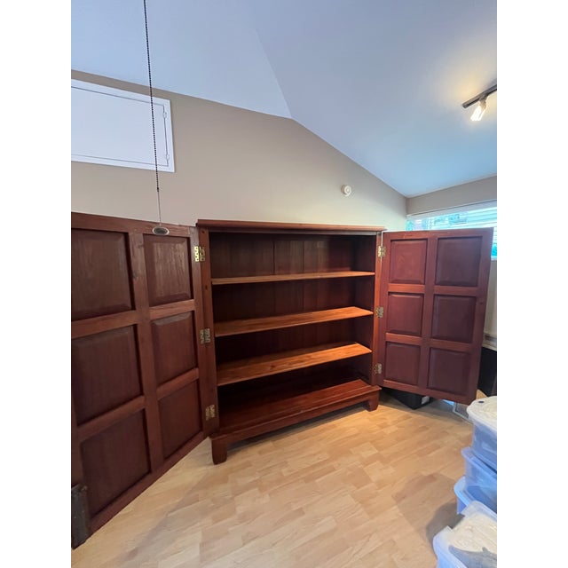 Monumental antique Chinese temple-style storage cabinet crafted in solid teak with exceptional presence and scale....