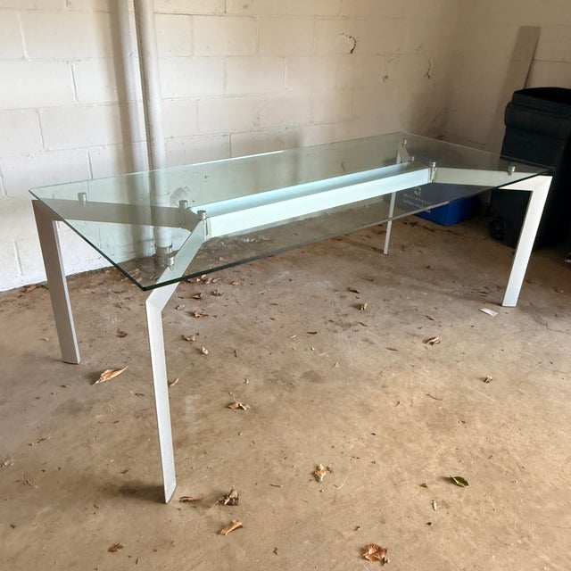 Makio Hasuike Glass Table for Seccose A modern and industrial dining table with an architectural aluminum base and a...