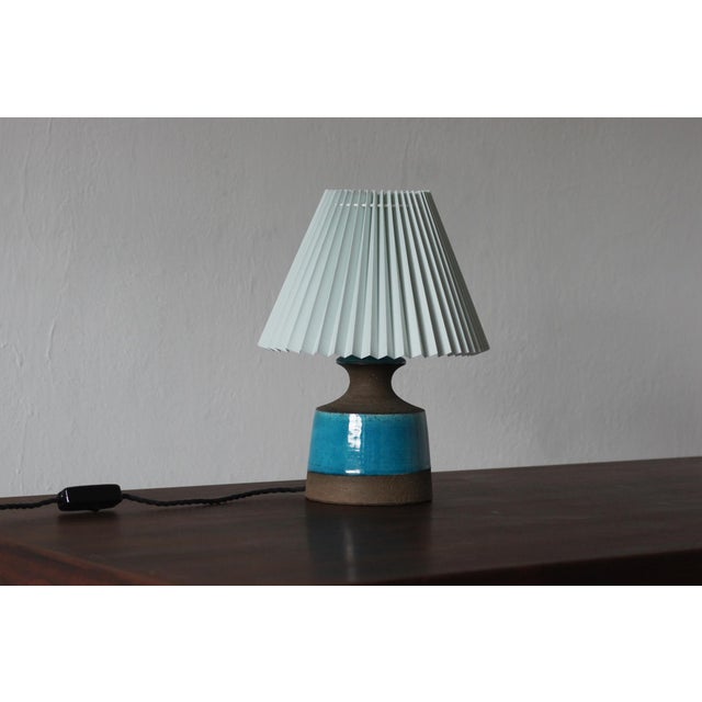 This vintage Danish ceramic lamp is a beautiful example of Scandinavian design, where simplicity of form goes hand in hand...