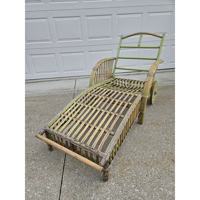This weathered green bamboo and reed patio, or outdoor chaise lounge has lots of charm. We love the big chunky wheels!...