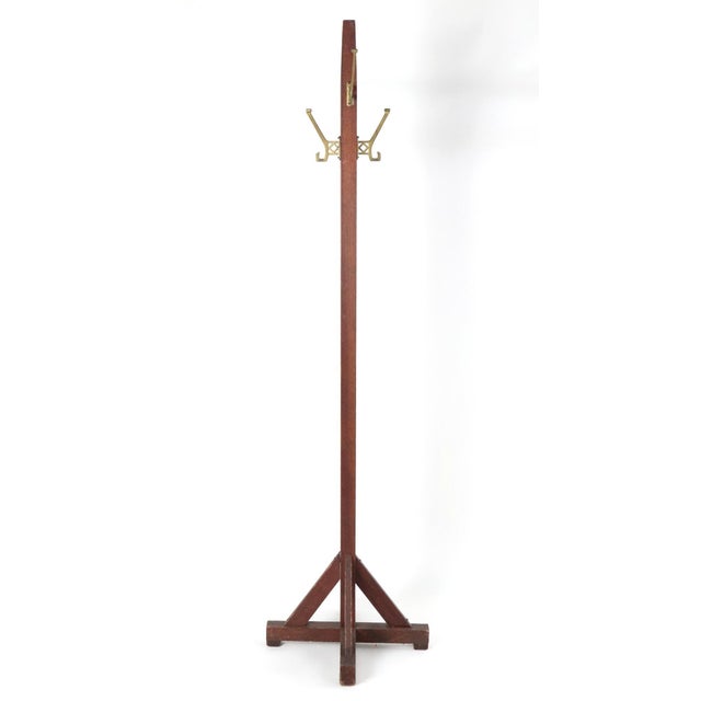 Vintage oak coat tree rack supported by a sturdy four foot base with angled braces, a classic Arts & Crafts design...