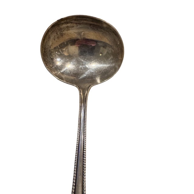 A Gorham sterling silver soup or punch ladle in the "Lancaster" pattern made between 1897-1991. It has a gilt inner bowl....