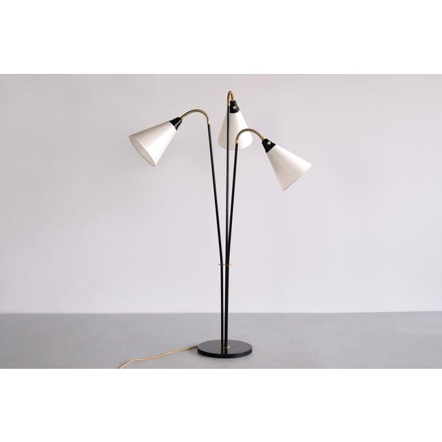 This rare three arm floor lamp was produced in Sweden in the 1950s. The design is marked by the three individual arms,...