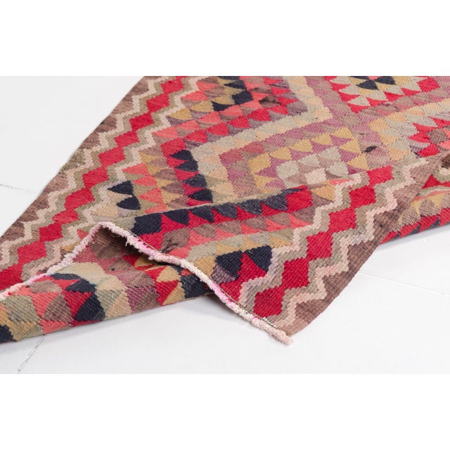 This is a vintage Turkish Oushak rug from the Mid 20th Century. The piece was hand-knotted.