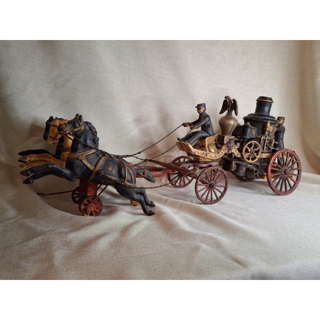 Historical Provenance & Design Significance This commanding 21-inch cast iron triple-hitch fire pumper stands as a...