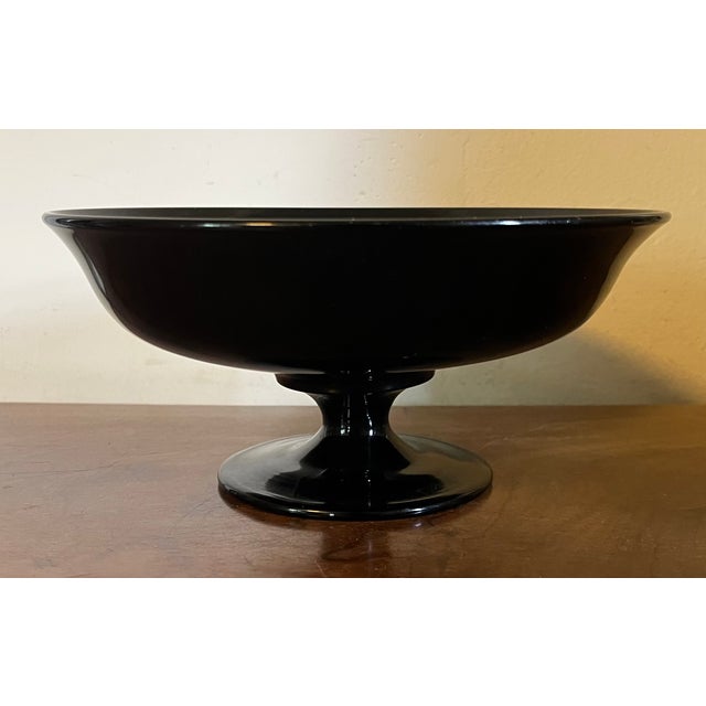 Antique early 20th century black amethyst glass footed fruit bowl or centerpiece tazza. Measures 8 1/8" diameter x 3 3/4"...