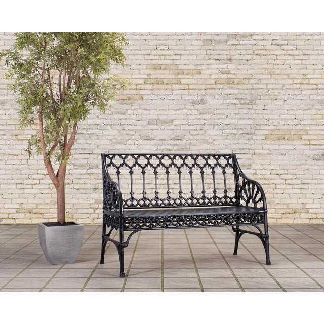 A dramatic sculptural two-seat garden bench made out of cast aluminum and iron in the English Gothic Coalbrookdale foundry...
