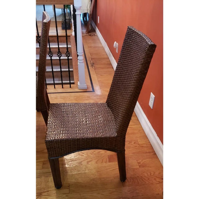 Rustic Table With 4 Matching Hi Back Chairs. Chairs are weaved resin wicker look. Wide seating. The glass has small chip...