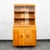 Solid birch china cabinet by Heywood Wakefield. Comes in the original champagne finish. The top has double glass sliding...