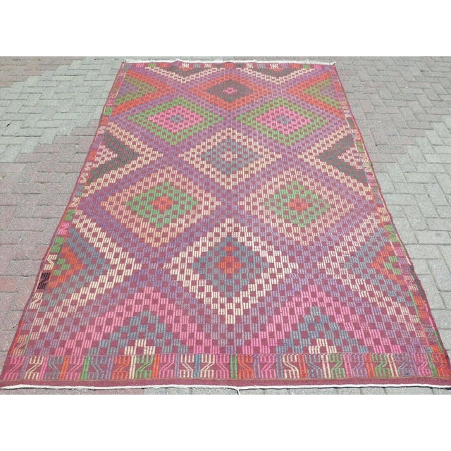 This beautiful, traditional vintage, flatweaved Turkish kilim rug is approximately 60 years old. It is handmade of very...