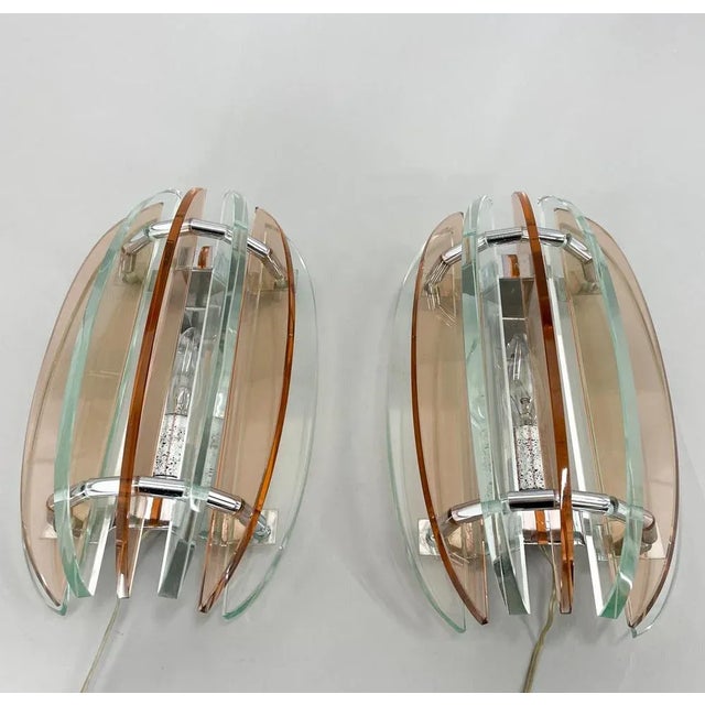 Set of two beatiful wall lamps by veca italy. Made of murano glass in pastel colours and chrome. Labeled by manufacturer....