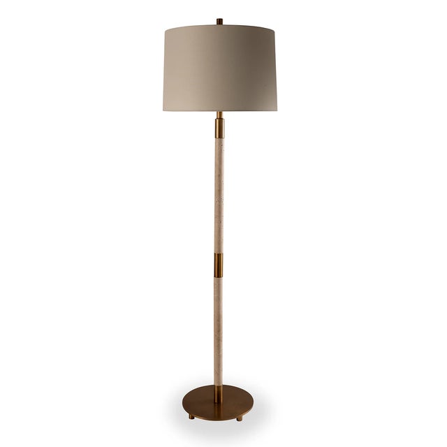 Natural unpolished stone marble turnings are accented with aged brass finished metal hardware for this Trivoli floor lamp....