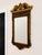 Striking Italian Georgian style wall mirror featuring an exceptionally ornate carved and parcel-gilt frame with a rich...