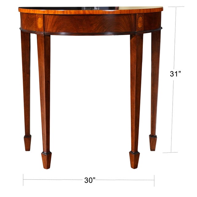 A high quality Small Mahogany Banded Console table from Niagara Furniture which makes elaborate use of hand cut inlays....