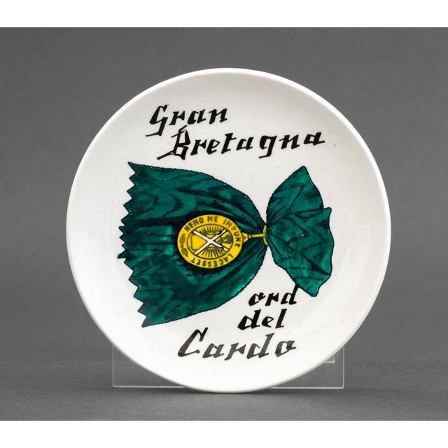 Set of Seven Piero Fornasetti "Al Merito" Porcelain Coasters, with painted embellishments to the lithograph medals, marked...