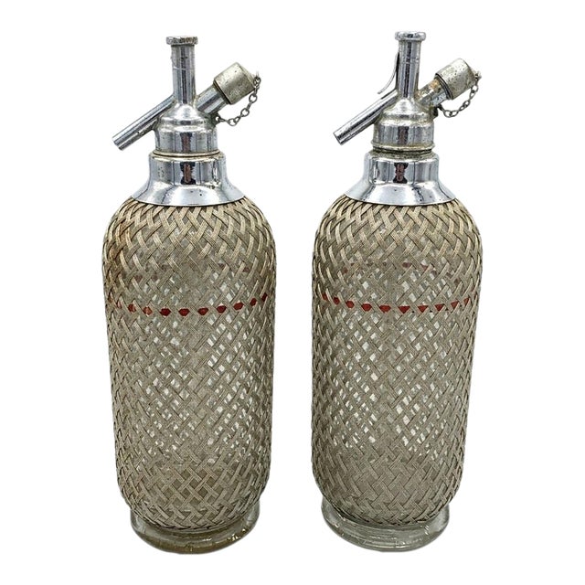 Sparklets Ltd. London, English Seltzer Bottles / Soda Siphons With Original Straws, Red Fill Bands & Woven Metal Mesh - Mid-20th Century Pair For Sale