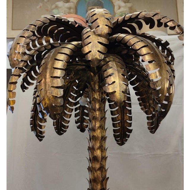 Maison Jansen palm tree floor lamp. Made entirely by hand on a metal base in aged and worn gold. Square base with metal...