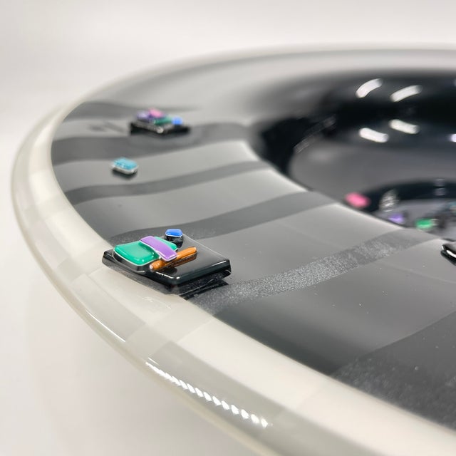 A striking example of late 20th-century American studio art glass, this large fused glass charger by renowned...
