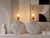 A striking pair of 1980’s Postmodern table lamps featuring sculptural round plaster bodies with raised geometric diamond...