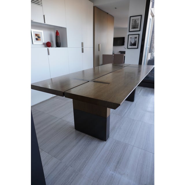 Holly Hunt Studio Walnut Split Dining Table is a contemporary showpiece with a two-piece tabletop featuring meticulously...