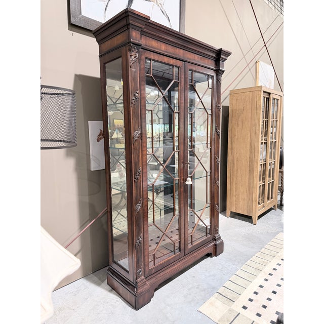 A richly appointed Henredon display cabinet crafted in a deep mahogany finish with refined Georgian influence throughout....
