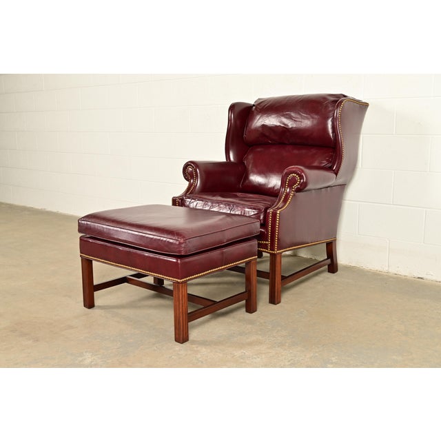 A gorgeous Chippendale style wingback library chair, lounge chair, or fireside chair with ottoman By Hancock & Moore USA,...